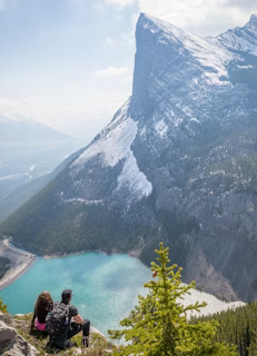 couple at the peak facing mountain couple at the peak facing mountain