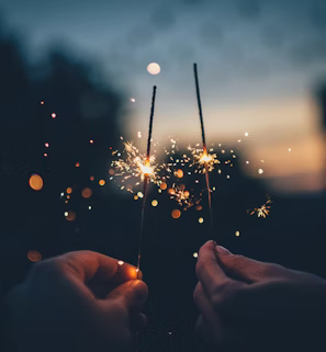 person holding fire cracker shallow focus photography person holding fire cracker shallow focus photography