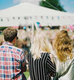 three person's standing front of field three person's standing front of field