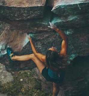 photo of woman climbing mountain