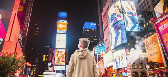 man standing on road infront of high-rise buildi man standing on road infront of high-rise buildi