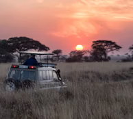 man riding on gray car during sunset man riding on gray car during sunset