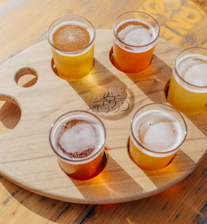five poured drinking glasses on brown wooden tray five poured drinking glasses on brown wooden tray