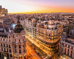 white wooden chairs on green grass field near body of water during daytime