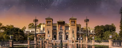 a large building sitting on top of a lake under a night sky a large building sitting on top of a lake under a night sky