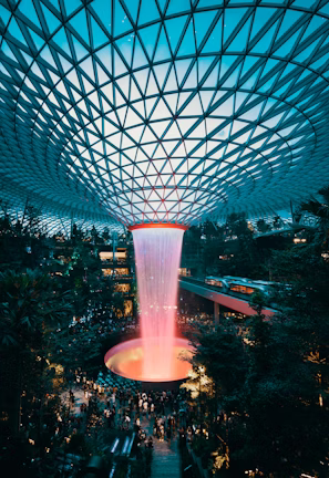water fountain inside building surrounded with crowd water fountain inside building surrounded with crowd