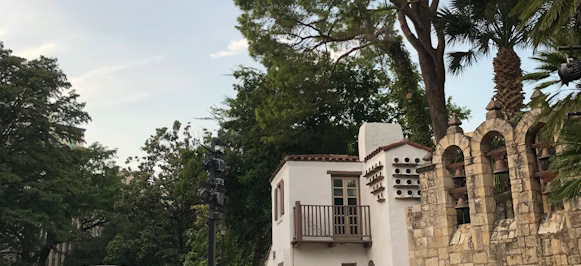brown concrete bridge beside white building brown concrete bridge beside white building
