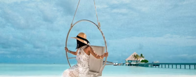 woman in white dress sitting on swing woman in white dress sitting on swing