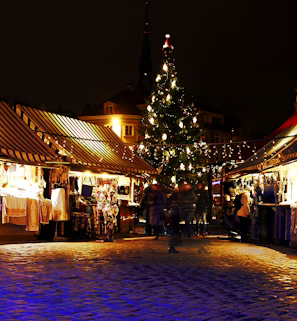 lighted Christmas tree surrounded by houses lighted Christmas tree surrounded by houses