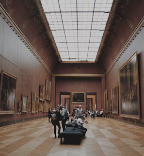 people walking on corridor looking at painting people walking on corridor looking at painting