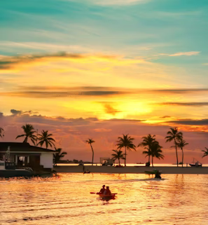silhouette photo of two person riding kayak silhouette photo of two person riding kayak