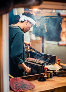 man in blue long sleeve shirt cooking man in blue long sleeve shirt cooking