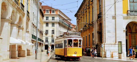 yellow and white tram on road during daytime yellow and white tram on road during daytime