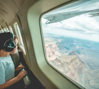 man in gray shirt holding black dslr camera