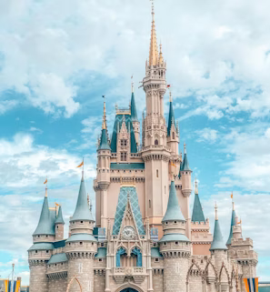 white and blue castle under blue sky and white clouds during daytime white and blue castle under blue sky and white clouds during daytime
