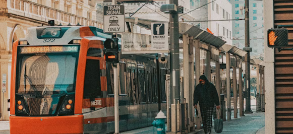 orange tram on the street during daytime orange tram on the street during daytime