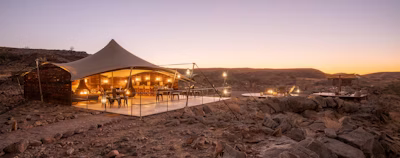 a tent set up in the middle of a desert a tent set up in the middle of a desert