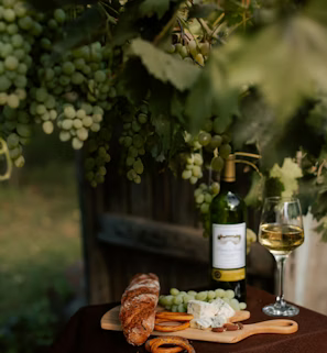 a bottle of wine and a plate of food on a table a bottle of wine and a plate of food on a table