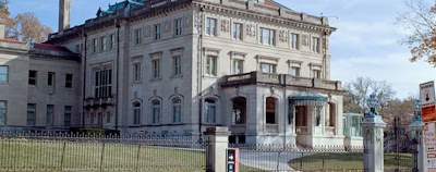 a large building with a fence around it a large building with a fence around it