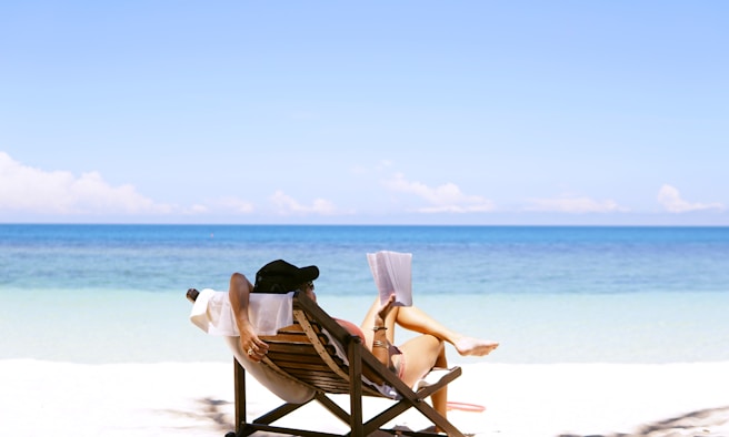 Brown wooden bench on beach during daytime