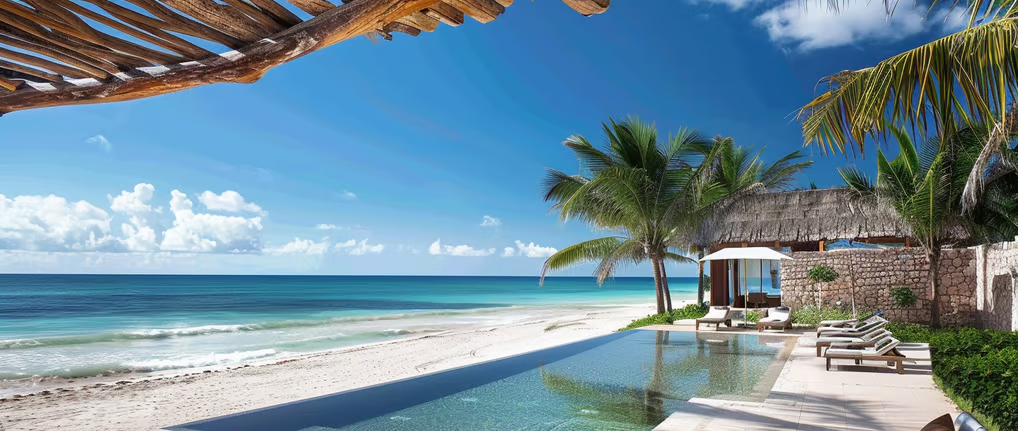 a beachfront home with a pool and lounge chairs a beachfront home with a pool and lounge chairs