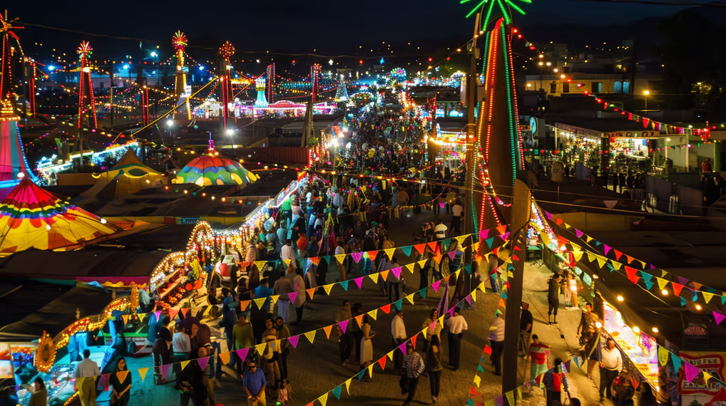 a carnival with people walking around at night in mexico