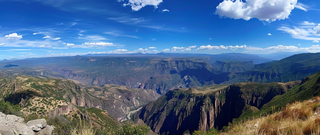 a mountain view of a valley with a few clouds in mexico