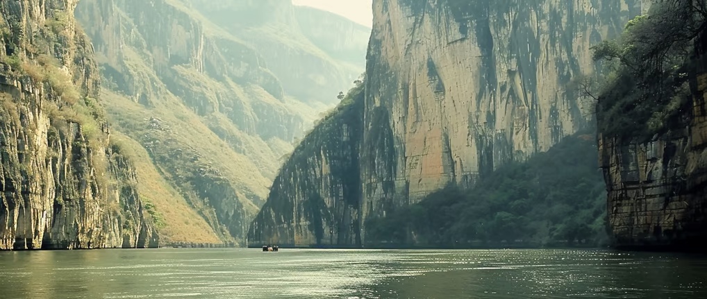 a boat in the water with a mountain in the background in mexico