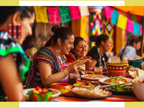 a group of people sitting at a table with food in mexico a group of people sitting at a table with food in mexico