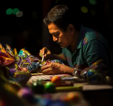 a man hand-painting a clay alebrije in Mexico