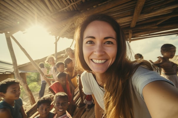 A European tourist taking a selfie with the local kids of an Indian town.