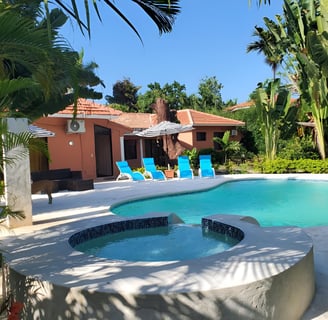 A pool with lounge chairs and umbrellas in puerto plata, dominican republic A pool with lounge chairs and umbrellas in puerto plata, dominican republic