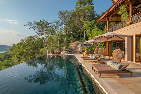 A large pool with lounge chairs and umbrellas in koh kong, cambodia A large pool with lounge chairs and umbrellas in koh kong, cambodia