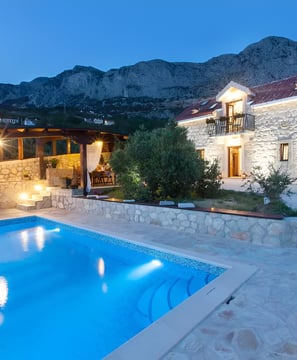A house with a pool and scenic mountain views
