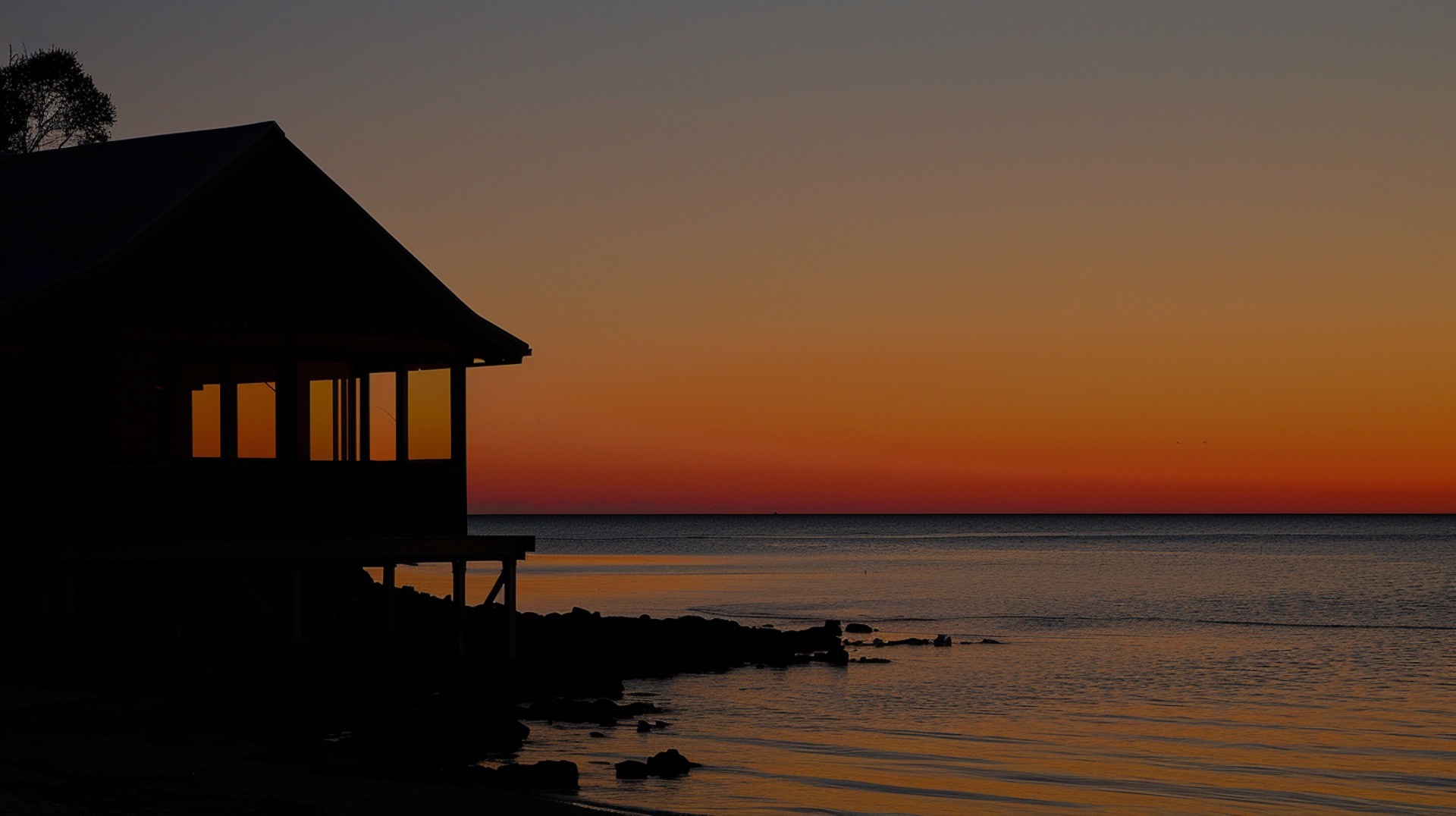A cottage at sea beach during sunset