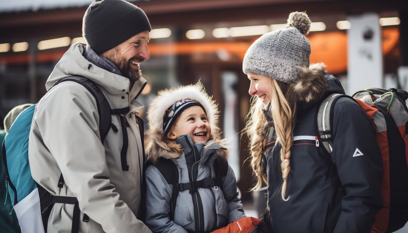 A smiling family wearing hats and carrying backpacks, enjoying a cheerful moment together outdoors. A smiling family wearing hats and carrying backpacks, enjoying a cheerful moment together outdoors.
