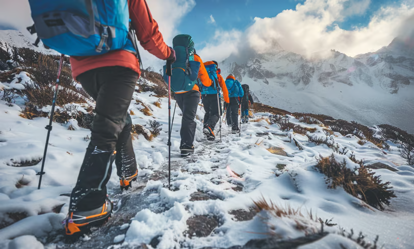 a group of mountaineers hiking a trail on Andes mountains during winter.