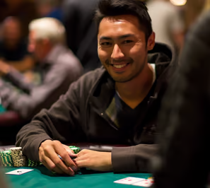 a male guest playing a hand at a poker table in Las Vegas. 