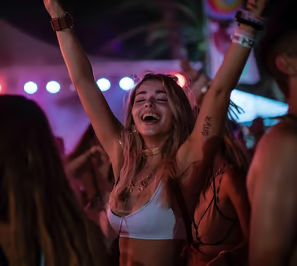 A lady tourist partying at an Ibiza beach at night.